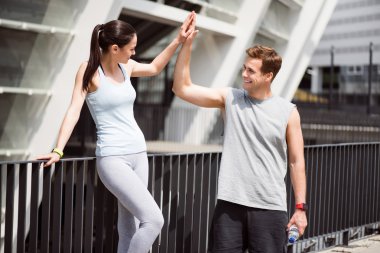 Man giving five to a woman