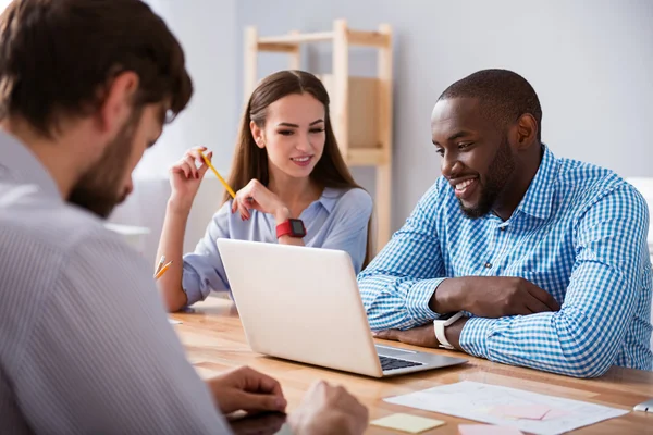 Positive colleagues sitting at the table — Stock Photo, Image