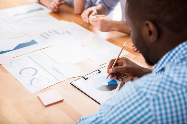 Pleasant involved man sitting at the table — Stock Photo, Image