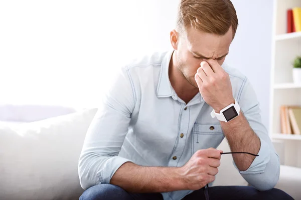 Kranker Mann sitzt auf der Couch — Stockfoto