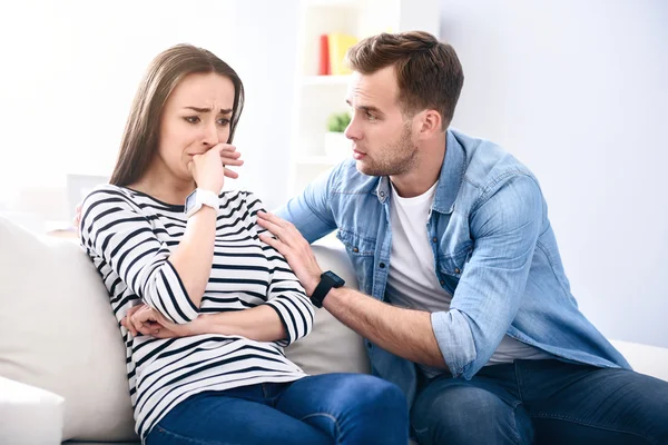 Moody woman sitting on the couch — Stock Photo, Image