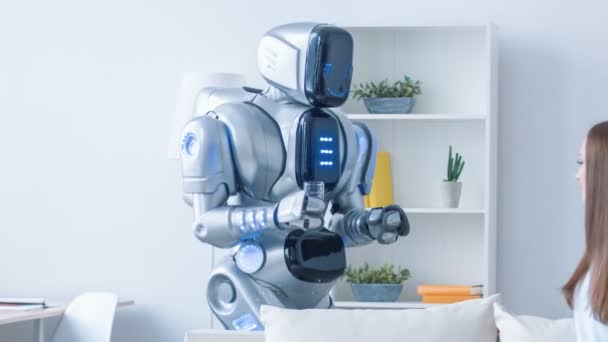 Trevlig robot ger glas vatten till en kvinna — Stockvideo