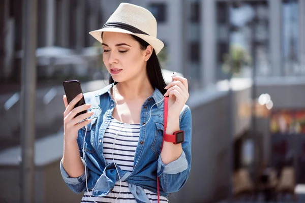 Pleasant beautiful woman holding cell phone