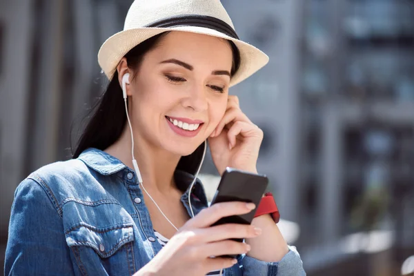 Cheerful woman listening to music