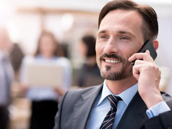 Positive businessman talking on cell phone — Stock Photo, Image