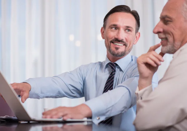 Positive smiling colleagues sitting at the table — Stock Photo, Image