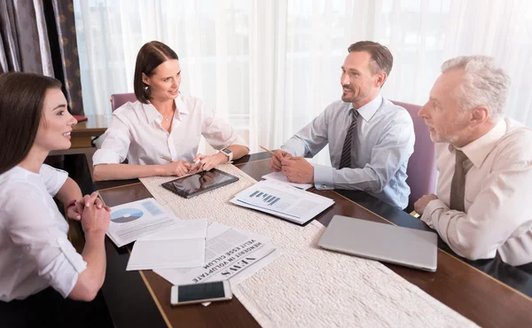 Cheerful colleagues sitting at the table — Stock Photo, Image