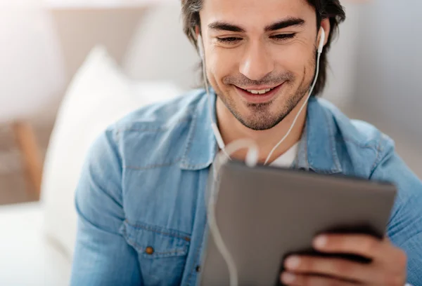 Positive smiling man using tablet — Stock Photo, Image