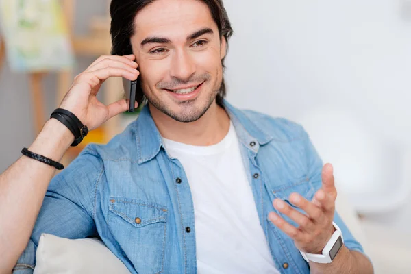 Pleasant handsome man talking on smartphone — Stock Photo, Image