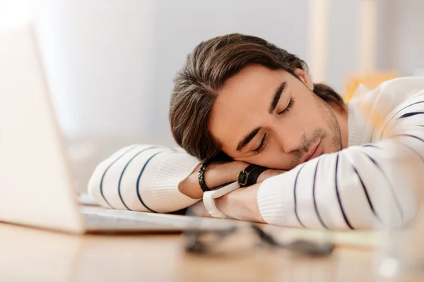 Pleasant man sleeping at the table — Stock Photo, Image