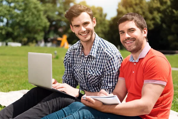 Joven positivo usando un portátil — Foto de Stock