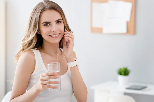 Delighted smiling woman drinking water — Stock Photo, Image