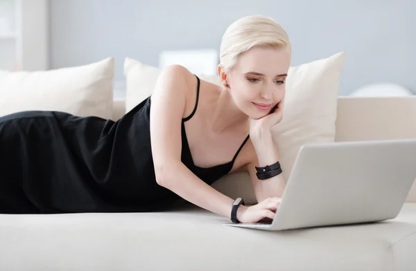 Mujer acostada en la cama con portátil —  Fotos de Stock