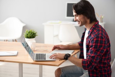 Dizüstü bilgisayar kullanan olumlu adam