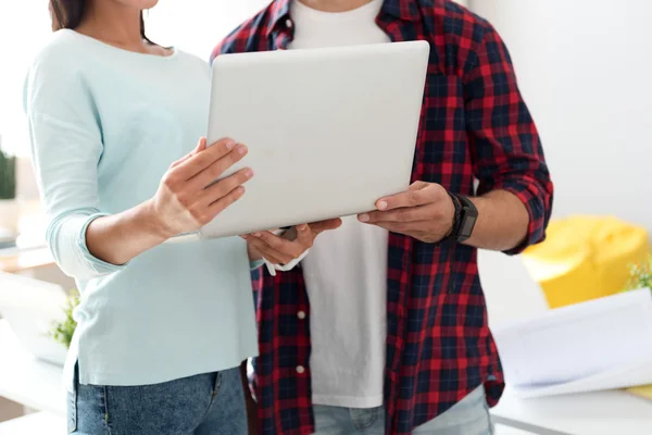 Pleasant colleagues using laptop — Stock Photo, Image