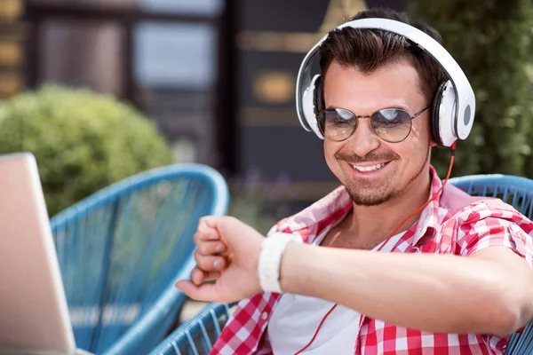 Cheerful man listening to music