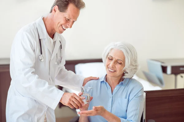 Senior patient taking pills