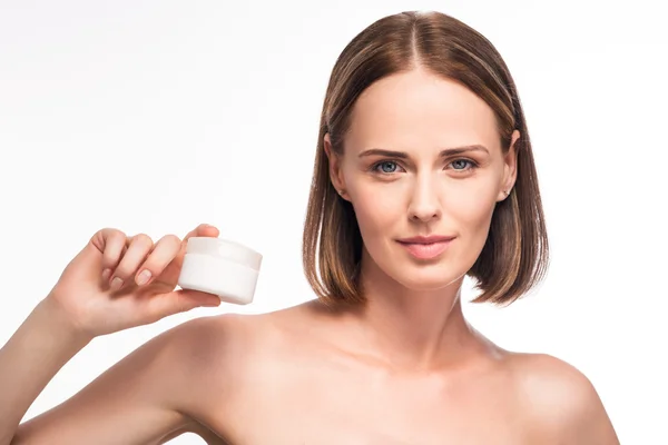 Attractive young woman holding cosmetic — Stock Photo, Image