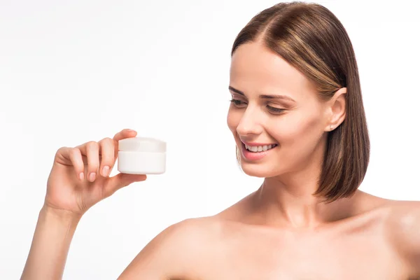 Cute young woman holding cosmetics — Stock Photo, Image