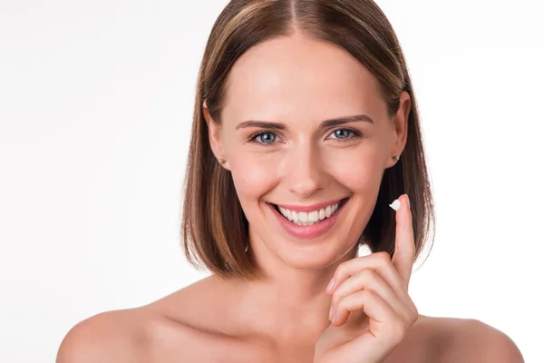 Nice young woman holding cream — Stock Photo, Image