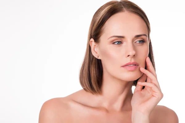 Wistful young woman applying cosmetics — Stock Photo, Image