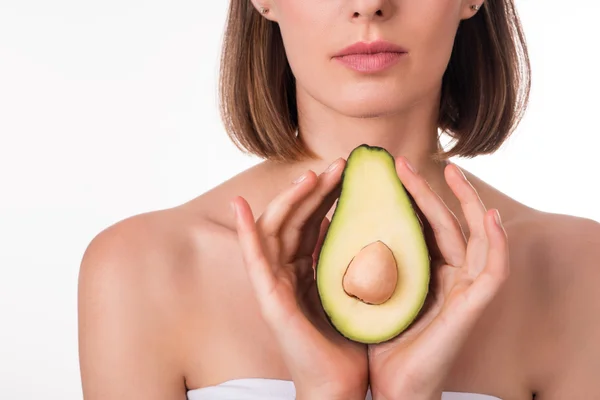 Delighted young woman holding avocado — Stock Photo, Image