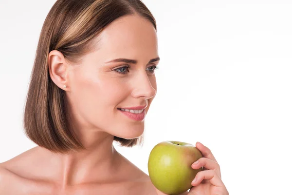 Positive young woman holding an apple — Stock Photo, Image