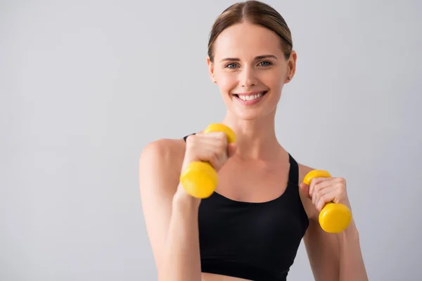 Cute young woman with dumb bells — Stock Photo, Image
