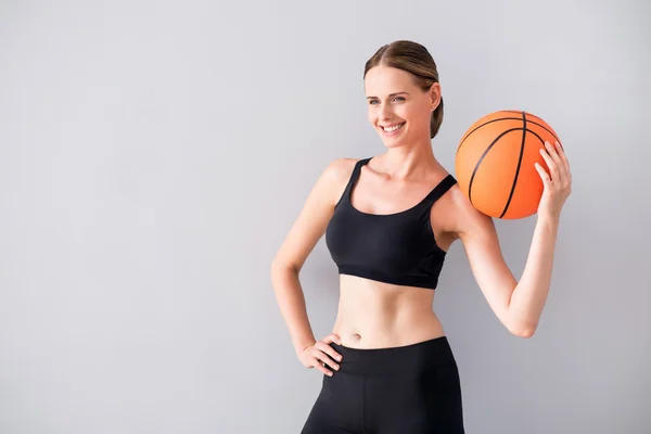 Beautiful young woman holding ball — Stock Photo, Image