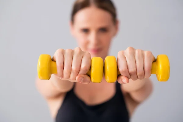 Nice young woman with dumbbells — Stock Photo, Image