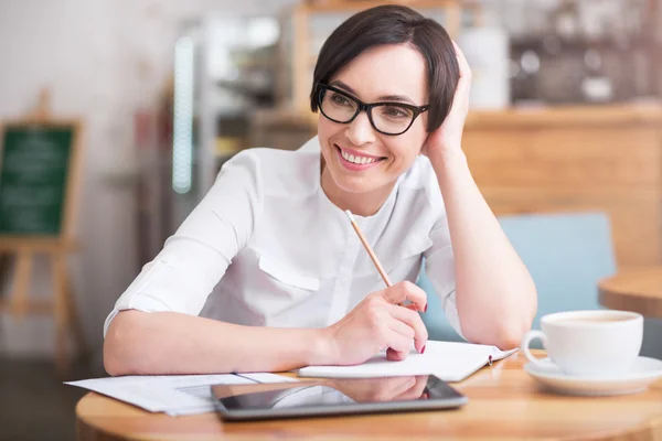 Attractive businesswoman sitting at table — Stock Photo, Image