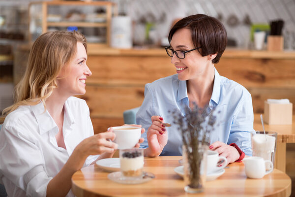 Cute women eating and drinking