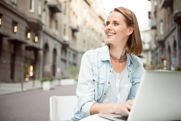 Mujer sonriente alegre sentada en el café — Foto de Stock