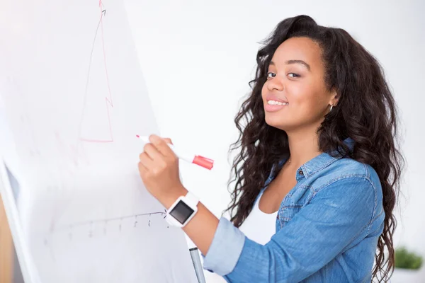 Positive woman drawing the graph on the board — Stock Photo, Image