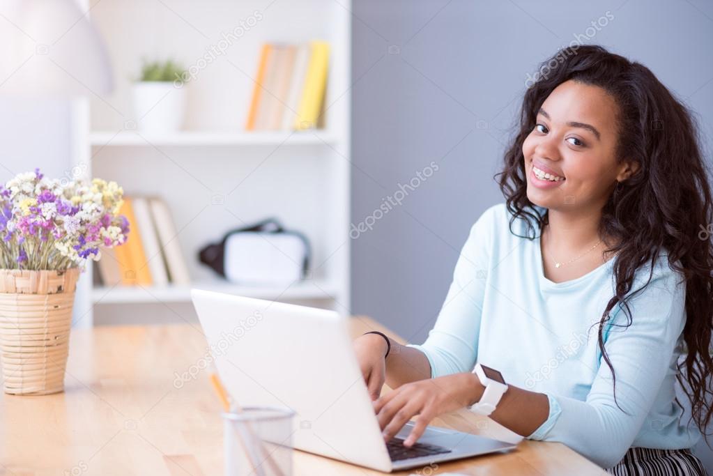 Joyful smiling woman using laptop