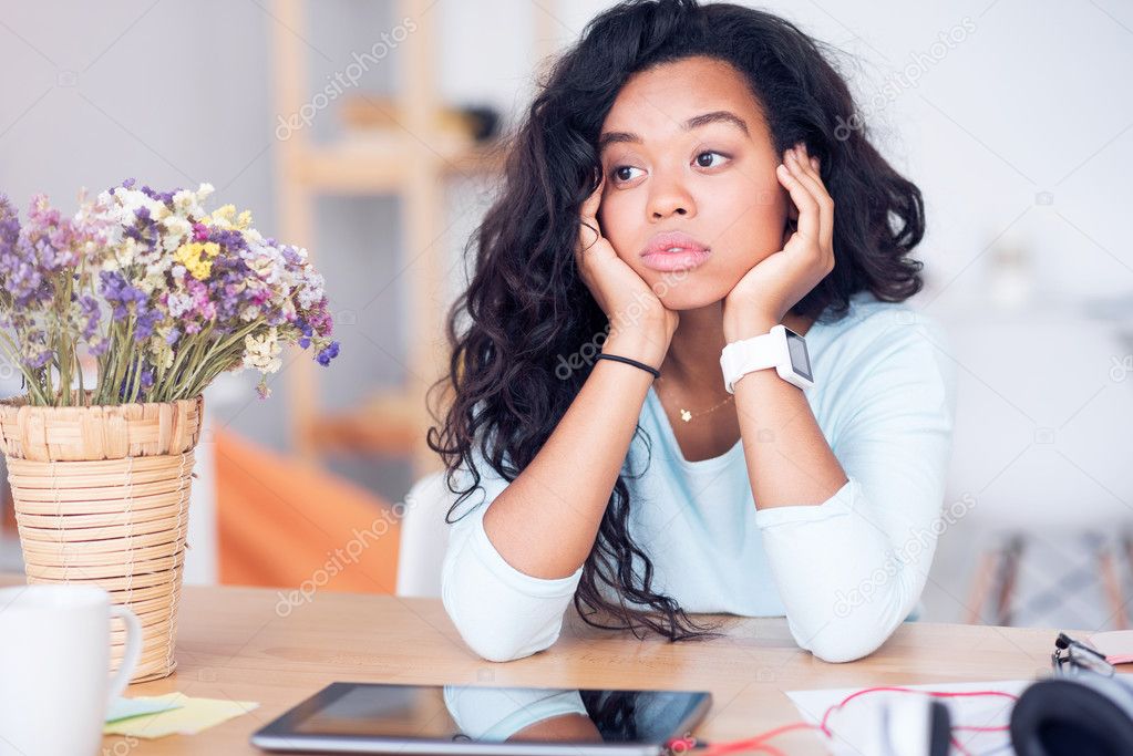 Tired woman sitting at the table