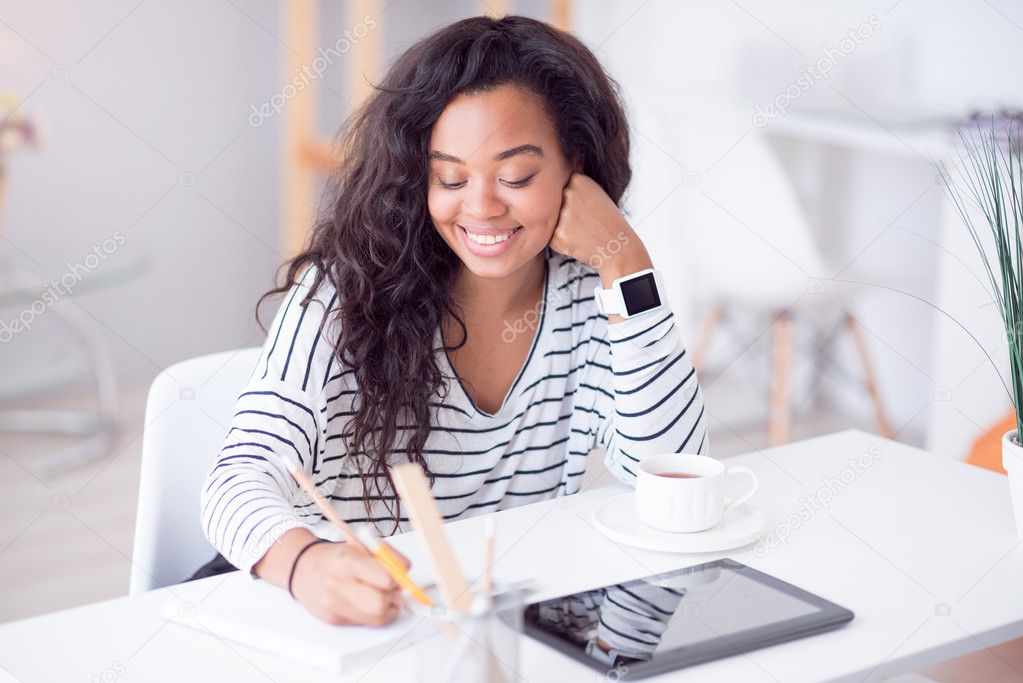 Cheerful beautiful woman sitting at the table