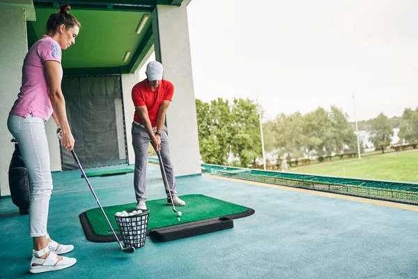 Treinador de golfe profissional demonstrando um golpe de colocação — Fotografia de Stock
