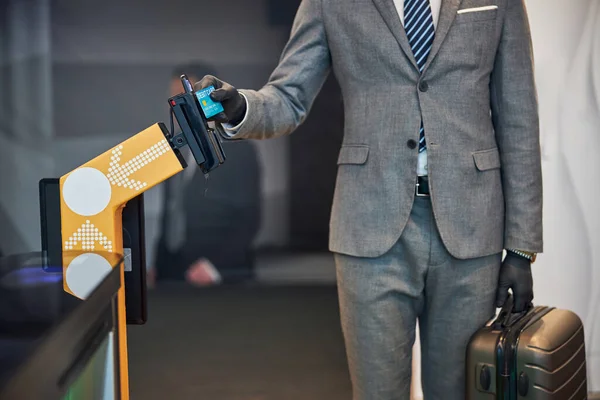 Business specialist conducting payment at a ticket barrier