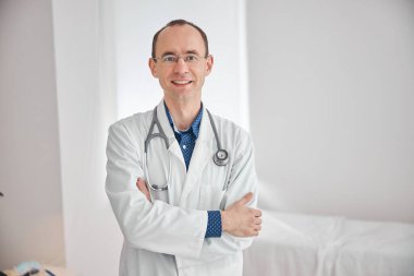 Boynunda steteskop olan mutlu bir doktor, geleceğe bakıyor.