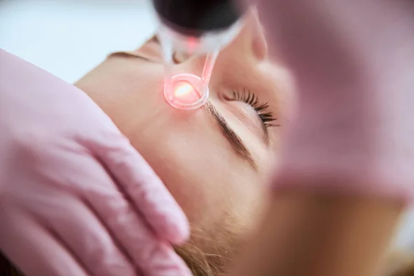 Caucasian female getting a laser skin treatment — Stock Photo, Image