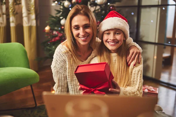 Happy woman with daughter opening presents on Boxing Day — Stock Photo, Image