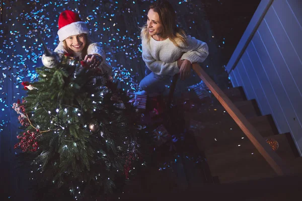 Happy family trimming New Year tree together — Stock Photo, Image