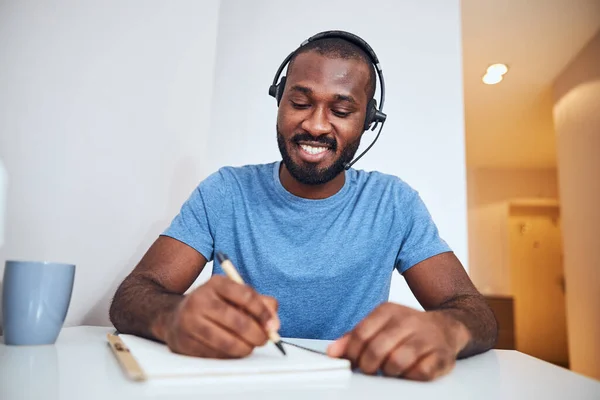 Hombre haciendo notas con un auricular —  Fotos de Stock