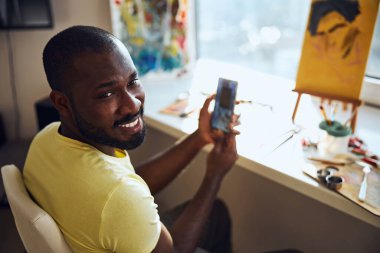 Erkek sanatçı bir portre fotoğrafından yüz çeviriyor.