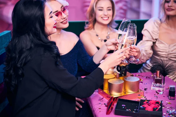 Quatro mulheres com bebidas alcoólicas sentadas na festa — Fotografia de Stock