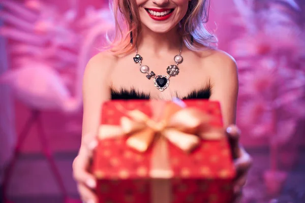 Happy lady demonstrating her present in front of the camera — Stock Photo, Image