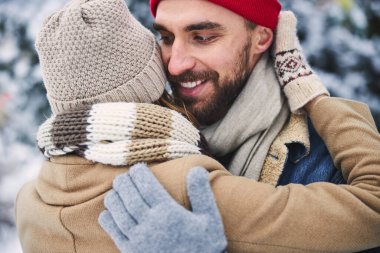 Neşeli çift kış gününü ormanda geçiriyor.