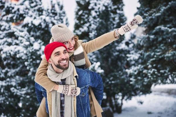 Felice fidanzato di equitazione femminile nella foresta innevata — Foto Stock