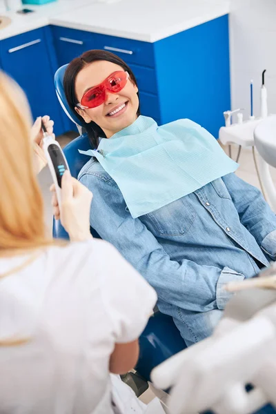 Mujer alegre mirando a su estomatólogo — Foto de Stock